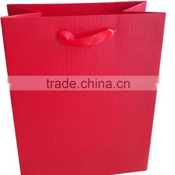 Red paper shopping gift paper bag with ribbon handle