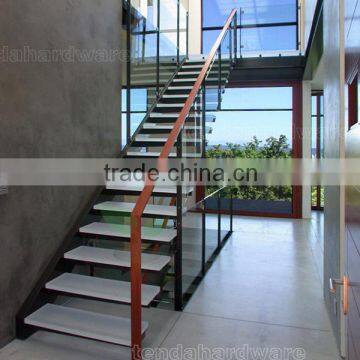 indoor floating stairs with marble tread and glass guardrails