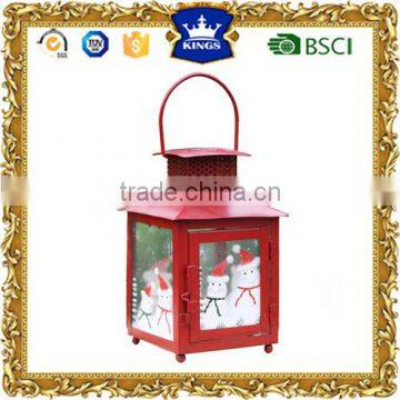 Small hanging red christmas metal candle lantern with snowman