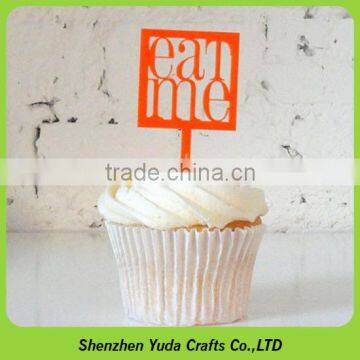 Bright orange decorational accessaries on cake, plexiglass cupcake topper in dessert shops