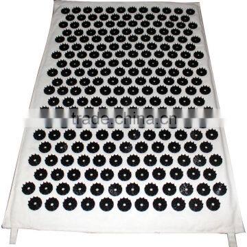 yoga acupressure mats with black buttons on white cotton fabric