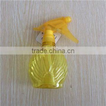 yellow transparent plastic garden spray bottle with trigger