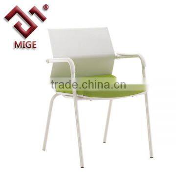 Green and white plastic stacking chairs