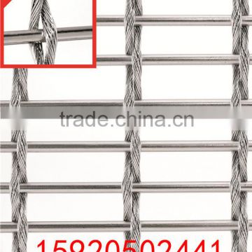 Tensioned woven wire facade