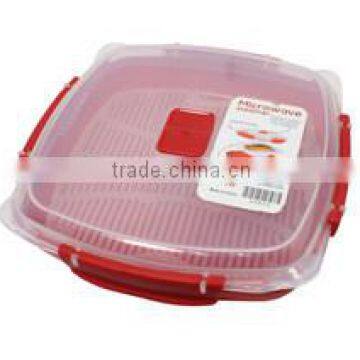 Red color plastic rice steamer in micrrowave oven