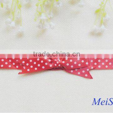 Red pre made satin ribbon bow with white polka dots for gift box packing