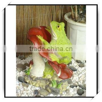 Animal decoration green frog on a red mushroom outdoor decor