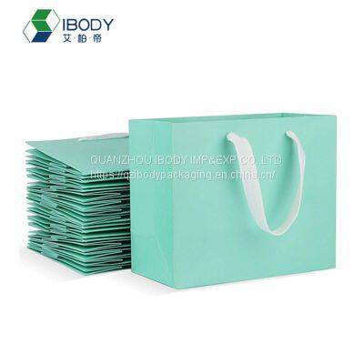 Customized luxury golden hot stamping shopping bag with ribbon handle white cardboard paper bag