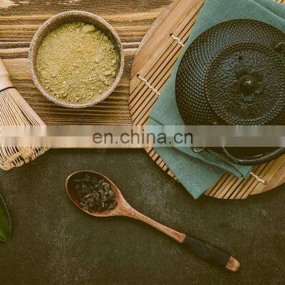 Black Cast Iron Tea Pot With Herbal Tea Set up Dark Stone Background
