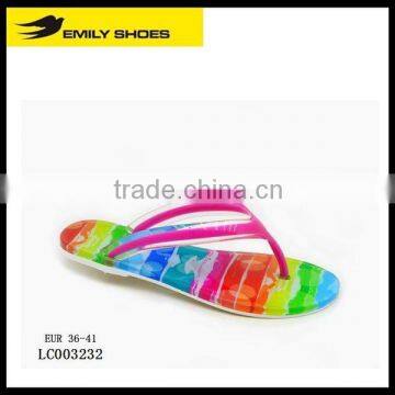 Lady's colourful flip flops with rainbow pattern