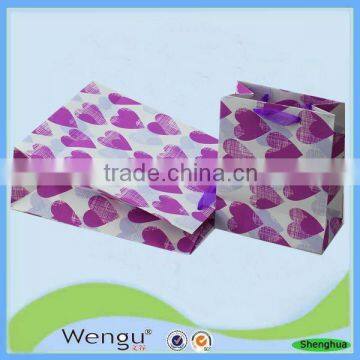 Unique design new fancy purple foaming gift paper bag with stain ribbon handle for packaging