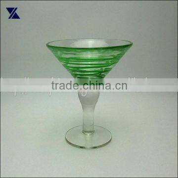 clear martini cocktail glass with green swirl clear stem