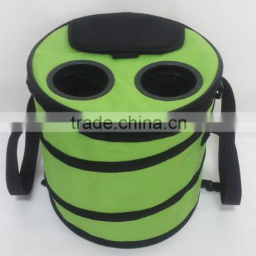 Green waterproof pop up cooler bag with black webbing and hand carrying