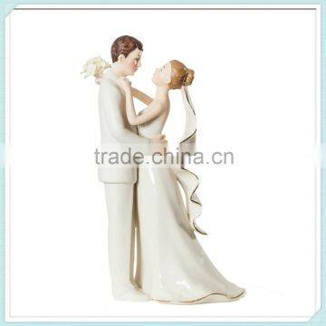 Pottery bride and groom wedding cake topper statue