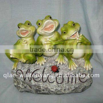 Polyresin frogs on rock with "Welcome" sign