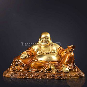 The bronze sitting laughing buddha statue is depicted as fat and smiling