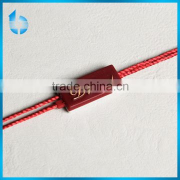 Yellow single insertion plastic string seal for garment hangtag