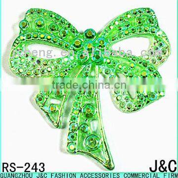 green color star effect bowknot shaped resin stone