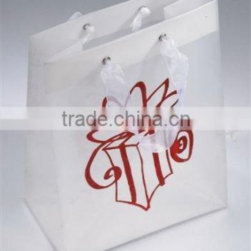 Plastic bag with ribbon handle