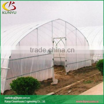 Sawtooth type high tunnel greenhouse growing vegetables in a greenhouse