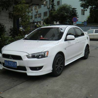 The Mitsubishi Lancer car is surrounded by front and rear ramps, and the ramps have chin corners