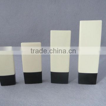 light yellow plastic cosmetic bottle with black cap