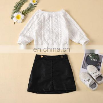 Children's clothing autumn and winter models solid color round neck twist knit pullover loose sweater leather skirt two-piece