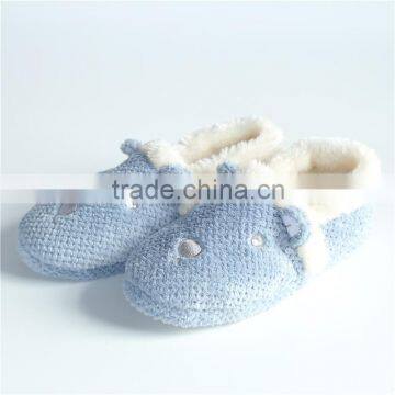 Woman tufting indoor slipper with embroidery