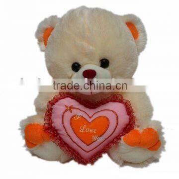 plush bear toy holding love heart