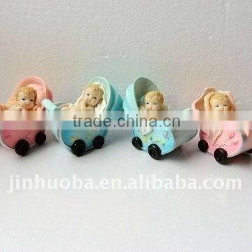 Polyresin baby figurine in baby bassinet