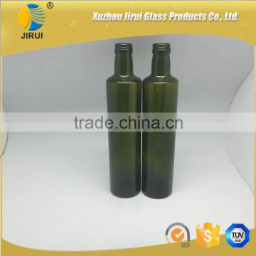 dark green round olive oil glass bottle with cap