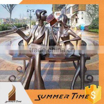 Brass modern couple sitting on chair statues