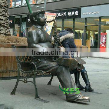 Brass man playing saxophone statue