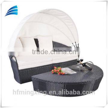 White outdoor patio daybed with canopy cover