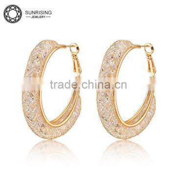 Atmospheric crystal round huggie earring with gold-plated