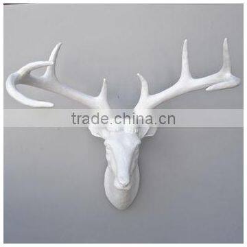 wall-mounted white deer head with hook at back