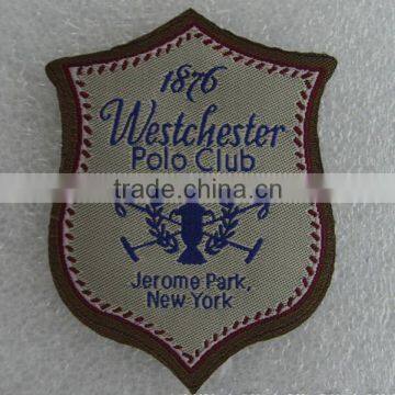 laser cut shield shape iron on woven badge for USA polo shirt