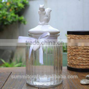 Glass storage jar with white decorative ceramic squirrel lid