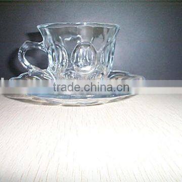 engraved glass cup and saucer