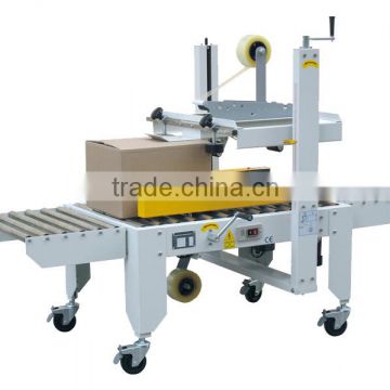 Automatic side drive carton sealer