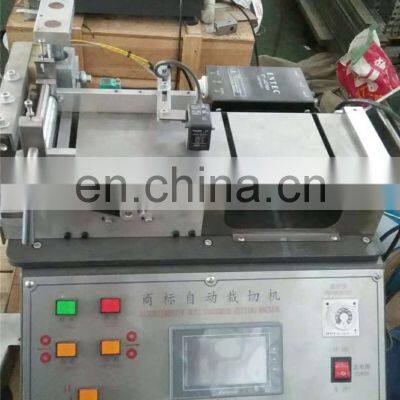 UGS2050 Hot Cold Mini Table Top Automatic Fabric Woven Label Cutting Machine, Small Garment Wash Care Ribbon Cutter photo-3