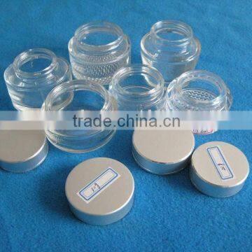 clear glass cosmetic cream container with various lid