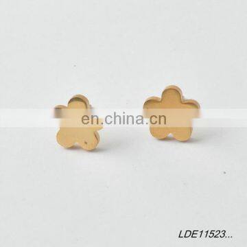 Worn gold flower earring