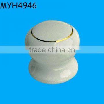 Plain white ceramic door knob with gold trim