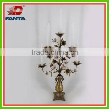 Noble golden iron candle holder with white porcelain flowers