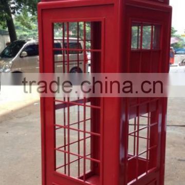 antique red painted metal street telephone booth