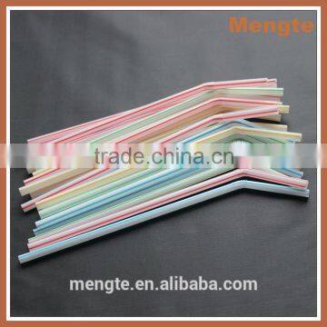 unwrapped green striped drinking straw