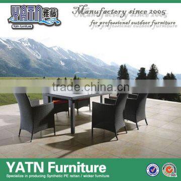 Foshan garden furniture plastic rattan chairs and table with glass