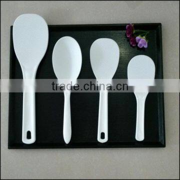 Long handle white plastic spoon for using in kitchen