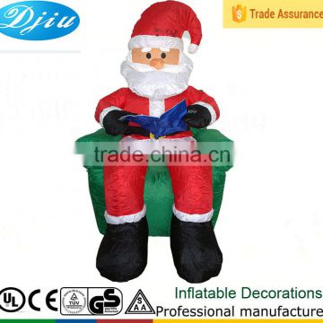 DJ-XT-17 inflatable Santa Claus read book on sofa indoor decoration